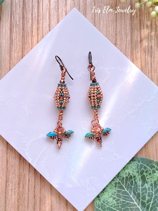 Pair of copper and turquoise beaded earrings on a white card with 'Iris Elm Jewelry' branding.