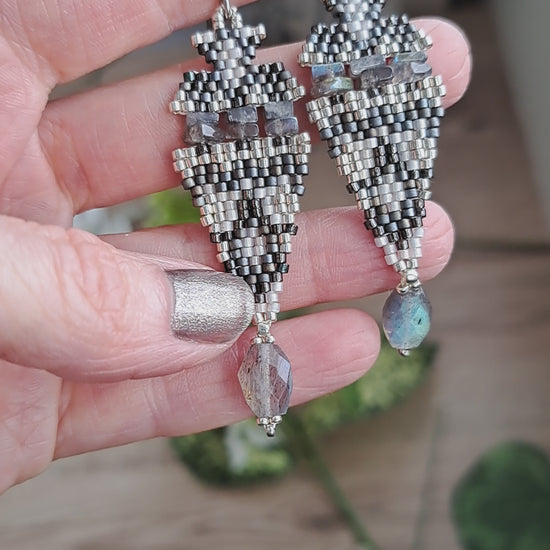 hand holding iridescent labradorite stone and seed bead boho beadwork earrings