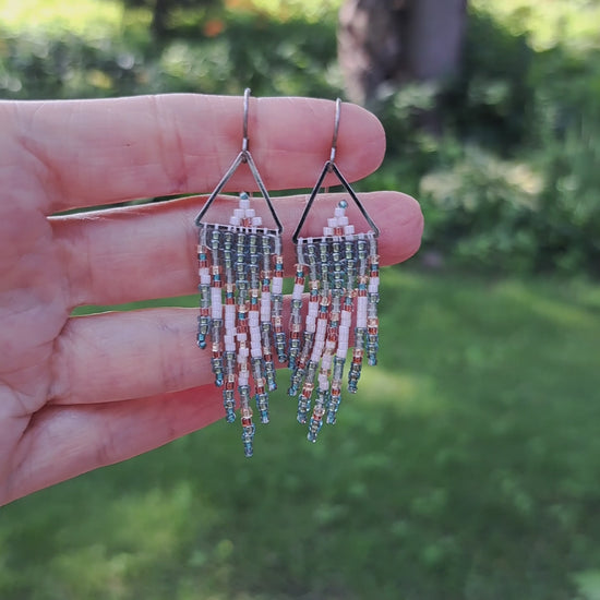 hand holding pair of small fringe earrings with triangle tops and turquoise, white, and copper seed beads